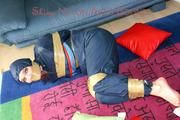 Jill tied, gagged and hooded on the floor with tape wearing an oldschool rain combination (Pics)