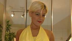 Busty Martina takes a hot bath in her yellow jumpsuit