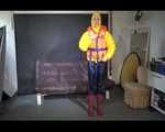 Sexy Mara trying on her new yellow down jacket and her lifevest in combination with a sexy shiny black rain pants and rubber boots (Video)