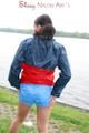 Sexy archive girl walking on a lake wearing a sexy shiny nylon shorts and an oldschool rain jacket (Pics)