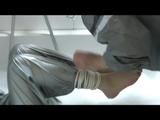 Simone  with an shiny silver PVC sauna suit tied and gagged by Sophie in an bath tub (Video)