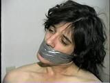 26 Yr OLD K-MART CLERK WRAP TAPE GAGGED WEARING BATHING CAP, MOUTH STUFFED. TIT TIED, CROTCH ROPED, NUDE, GARTER BELT & NYLON STOCKINGS TIGHTLY TIED TO A CHAIR (D63-13)