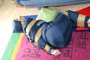 Jill tied, gagged and hooded on the floor with tape wearing an oldschool rain combination (Pics)