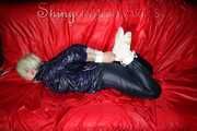 Sexy Courtney being tied and gagged with ropes and a ballgag on a bed wearing dark blue rainwear (Pics)