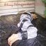 Pia tied and gagged with tape on a bed wearing a sexy silver rainwear combination (Pics) 