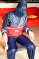 Katharina tied and gagged in a shiny nylon rainsuit