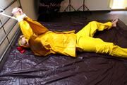 Pia tied and gagged in a shiny nylon rainsuit 
