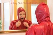Jill ties, gagges and hoodes herself in front of a mirror and in an strairway wearing a sexy shiny nylon rain pants in black and a red rain jacket (Pics)