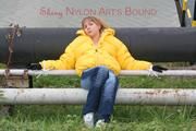 Leonie tied and gagged outdoor wearing a shiny yellow downjacket (Pics)