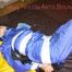 Lucy tied, gagged and hooded with tape by Sophie on bed wearing sexy lightblue rainwear (Pics)