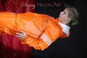 Watching Pia putting on a wonderful supersexy shiny nylon rainssuit in orange (Pics)