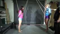 Aiyana and Ms Ungeniert in shiny nylon Shorts and Windbreaker tied and gagged together