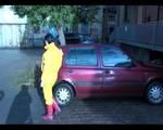 Jill wearing a yellow rain pants down jacket combination and rubber boots at home and outdoor (Video)
