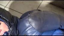 Jill bound and gagged in a shiny nylon downjacket