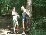 An archive girl tied and gagged on a tree by Jill both wearing shiny nylon shorts (Video)