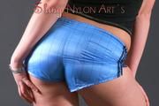 Beautiful archive girl posing in a photostudio wearing a supersexy shiny nylon shorts and a top (Pics)