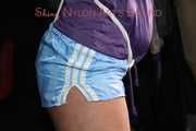 Watching Pia wearing a supersexy shiny nylon shorts and a rain jacket being tied and gagged overhead with ropes and a clothgag (Pics)