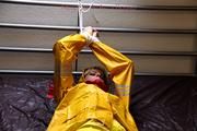 Pia tied and gagged in a shiny nylon rainsuit 