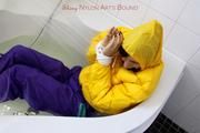 Julia tied and gagged in a ski suit in the bath tub