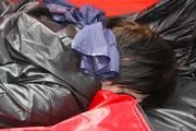 Simone tied and gagged in a big shiny nylon bag to lie in wearing a black shiny nylon shorts and a black shiny nylon rainjacket (Pics)