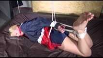 ***HOT HOT HOT*** PIA tied and gagged on a bed with ropes on the ceiling wearing sexy blue/red shiny nylon shorts and a white shirt (Video)
