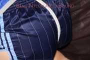 Sexy Sonja being tied and gagged on a sofa with ropes and a clothgag wearing a sexy oldschool blue shiny nylon shorts and a blue rain jacket (Pics)