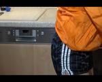 Sonja cleaning up the kitchen wearing a sexy black shiny nylon shorts and an orange rain jacket (Video)