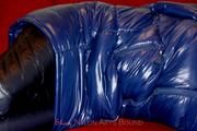 Samantha bound and gagged in a shiny nylon down coat