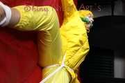 Watching sexy Pia being tied and gagged with ropes on a bed and a clothgag wearing sexy yellow shiny nylon rainwear (Pics)