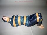 One of our archive girls tied and gagged in shiny nylon rainwear