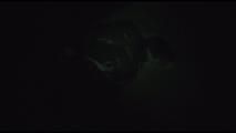 Jill tied, gagged and hooded on a cellar floor wearing a shiny green rain pants and a shiny black down jacket (Video)