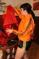Jill wearing a sexy black nylon shorts and a orange rain jacket while dressing her up (Pics)