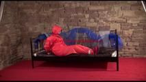 Jill tied, gagged and hooded on a princess bed wearing shiny orange rainwear (Video)