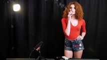 Skinny girl with wild red hair loves smoking a 120mm between the shooting