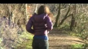 Alina wearing a jeans over a sexy shiny nylon shorts and a purple down jacket strolling on a lake (Video)