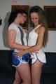 Jill and Petra touching eachother in front of a sofa wearing sexy shiny nylon shorts (Pics)