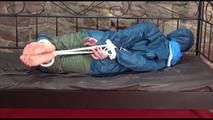 Jill tied and gagged in an old cellar wearing blue shiny nylon rainwear (Video)