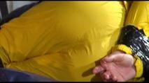 Sonja tied, gagged and hooded on bed with tape wearing a supersexy yellow rainwear combination (Video)