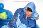 Simone tied and gagged in a shiny nylo skisuit