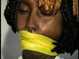 21 Yr OLD BLACK COLLEGE STUDENT GETS MOUTH STUFFED, WRAP TAPE GAGGED WHILE TIED TO A CHAIR  WEARING BLACK LINGERIE, GARTER BELT & HIGH HEELS (D65-4)