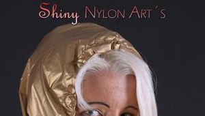 Blonde archive girl posing in a studio wearing a sexy golden rainwear combination (Pics)
