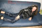 Petra lolling on the sofa wearing a sexy blue rainwear combination (Pics)