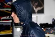 Simone tied and gagged in a shiny nylon rainsuit and a shiny nylon cape