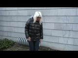 Blonde-haired archive girl going out wearing shiny nylon rainwear (Video)