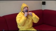Jill ties, gagges and hoodes herself wearing a shiny yellow down jacket and a yellow rain pants(Video)