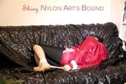 Mara tied and gagged on a black covered sofa wearing a supersexy red shiny nylon shorts over a leggings and a red rain jacket (Pics)