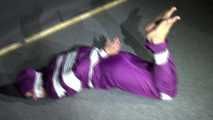 Sexy Sandra wearing a supersexy purple shiny nylon rainsuit bein tied and gagged and hooded on the floor with tape (Video)
