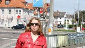 Katharina wearing a shiny nylon down jacket and a jeans while taking her dog out (Pics)