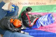 An archive girl tied and gagged in a sleepingsack by Jill on the floor both wearing shiny down jackets (Pics)