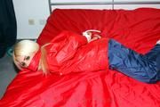 Nina tied and gagged in shiny nylon rainwear
